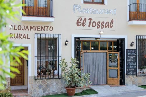 a building with a door and a sign on it at El Tossal in El Castell de Guadalest