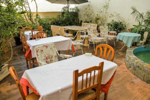a restaurant with tables and chairs and a swimming pool at El Tossal in El Castell de Guadalest