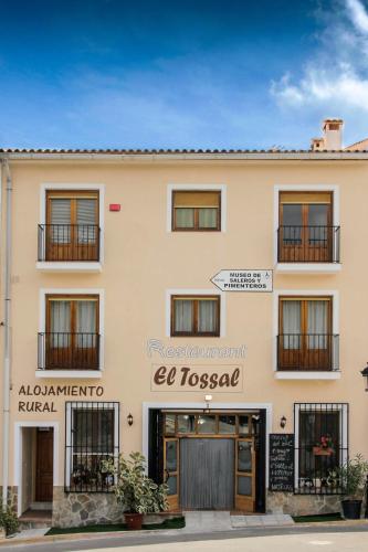 a building with a sign on the front of it at El Tossal in El Castell de Guadalest