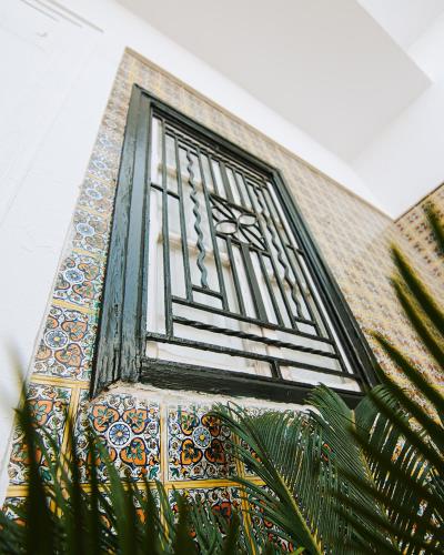 a window on a building with mosaics on it at DAR EL HAMRA in Mahdia