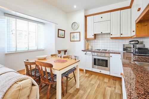 a kitchen with a table and chairs and a dining room at Host & Stay - Spinnaker in Newton by the Sea