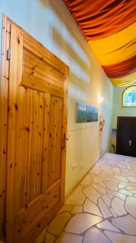 a large wooden door in a room with a floor at Naturnah bei Weimar in Nermsdorf