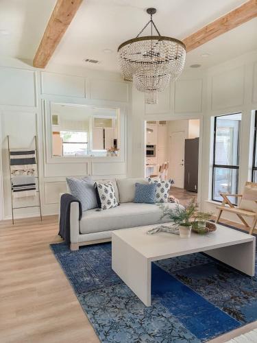 a living room with a couch and a coffee table at Luxe 4BR with Heated Pool and Hot Tub - Walk to Lake in Grapevine