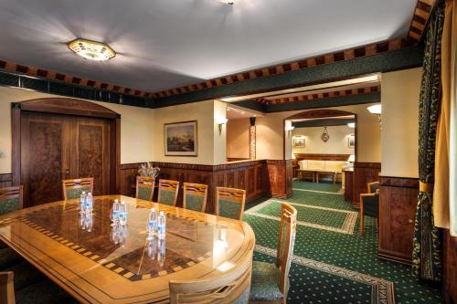 a conference room with a wooden table and chairs at Natsionalny Hotel in Kyiv