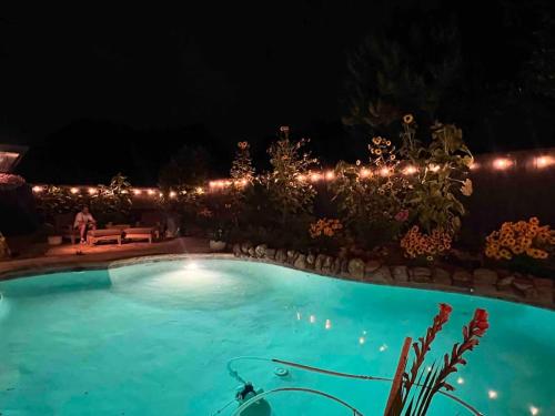a swimming pool at night with lights at Luxe 4BR with Heated Pool and Hot Tub - Walk to Lake in Grapevine