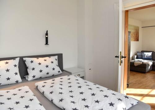 a bedroom with a bed with black and white pillows at Hallig Hüs 2 in Langeneß