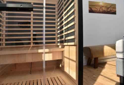 a living room with a window with blinds at Hallig Hüs 2 in Langeneß