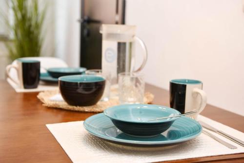 a table with three blue bowls on a table at Hallig Hüs 2 in Langeneß