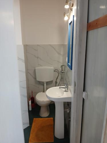 a bathroom with a white toilet and a sink at Beach Villa am Praia de Chaves, Boa Vista, Cabo Verde in Boa Ventura