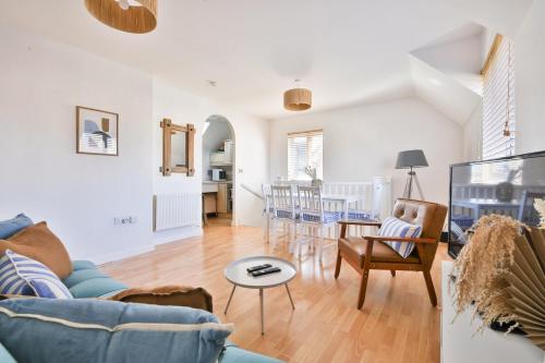 a living room with a blue couch and a table at Beach Breeze – Family 2-Bed Home in Barry in Barry