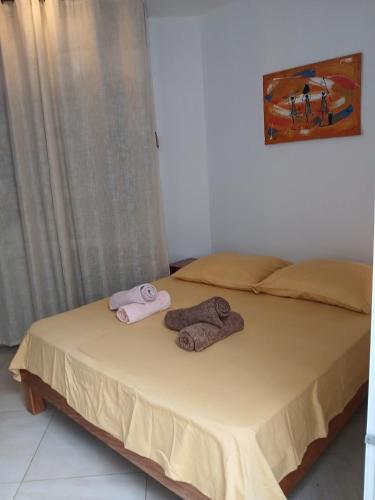 a bedroom with a bed with two towels on it at Beach Villa am Praia de Chaves, Boa Vista, Cabo Verde in Boa Ventura