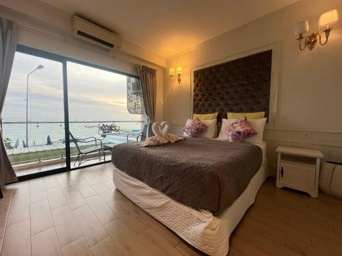 a bedroom with a large bed with a view of the ocean at Coco beach in Ban Bang Saen (1)