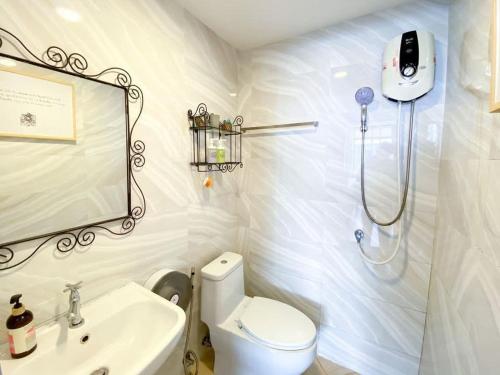 a bathroom with a shower and a toilet and a sink at Coco beach in Ban Bang Saen (1)