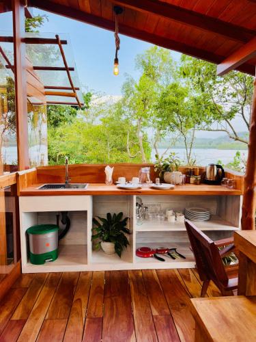 a kitchen with a counter with a sink and a window at Fisherman's Hut in Habaraduwa