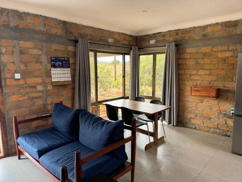 a living room with a blue couch and a table at Shiwa riverside apartment 