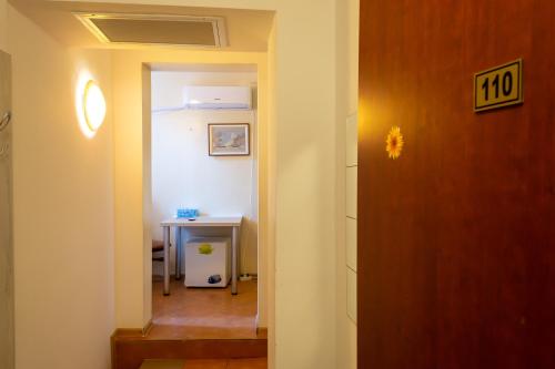 a hallway with a door leading to a room with a table at ElStefanino House in Eforie Nord