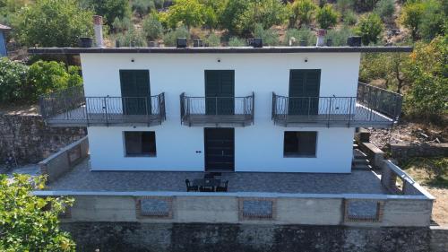 an aerial view of a white building with two balconies at Emerald House Shiroke in Shkodër