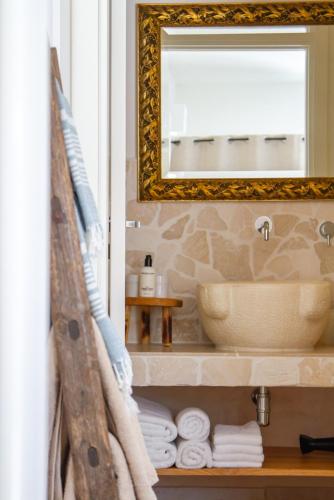 a bathroom with a sink and a mirror at Villa Gufo in Ostuni
