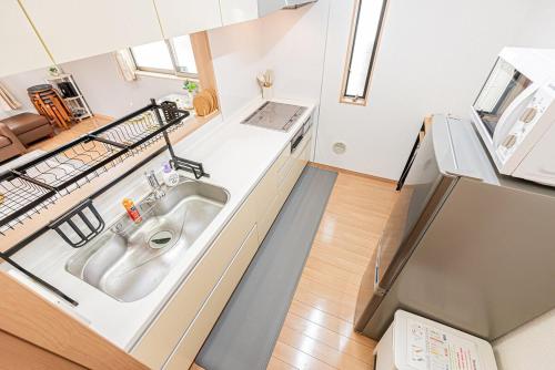 a kitchen with a sink and a counter top at Ohanachaya station 5-minute walk 4ldk house maxi 9people family friendly in Tokyo