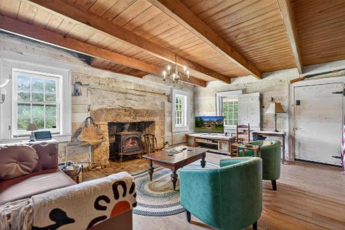 a living room filled with furniture and a fireplace at Historic 1802 Forge Home by North River & Trails in Capon Bridge
