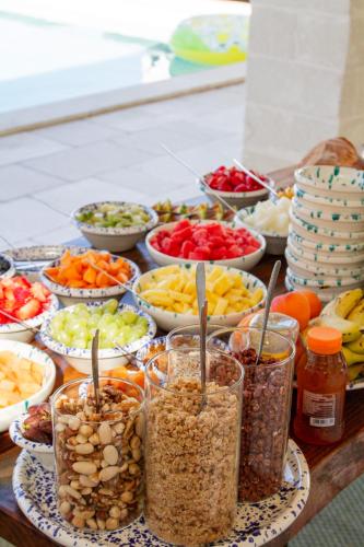 a table topped with bowls of different types of food at Villa Gufo in Ostuni