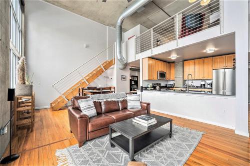 a living room with a couch and a table at Stylish City Loft Walk To Dining & Shops in Denver
