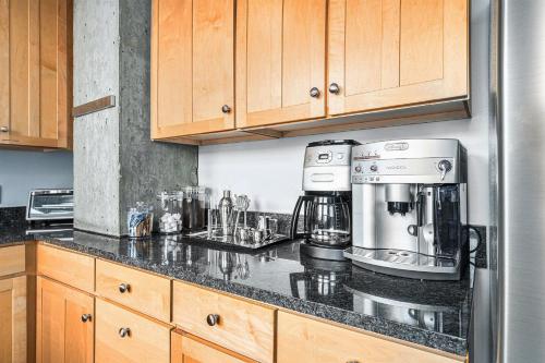 a kitchen with a coffee maker on a counter at Stylish City Loft Walk To Dining & Shops in Denver
