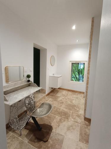 a bathroom with a sink and a mirror at Les Murmures Desbordes in Châteauvillain