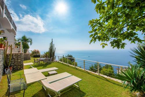 a view of the ocean from the backyard of a house at Wonderful villa with swimming pool overlooking the sea, 200 steps from the road in Conca dei Marini