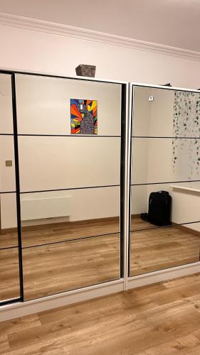 a wardrobe with glass doors in a room at Villa Vic in Grao de Castellón