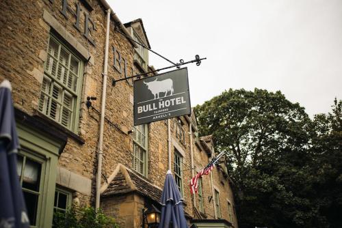 a sign for a bull hotel on the side of a building at The Bull Hotel in Fairford