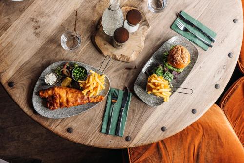 two plates of food on a wooden table at The Bull Hotel in Fairford