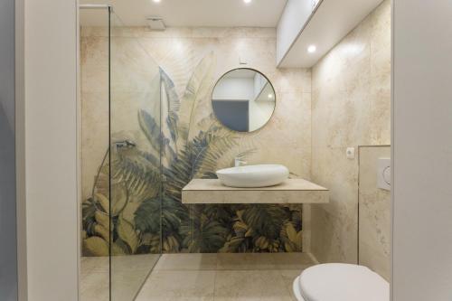 a bathroom with a sink and a mirror at Apartmant with Pool 8 in Kaštela