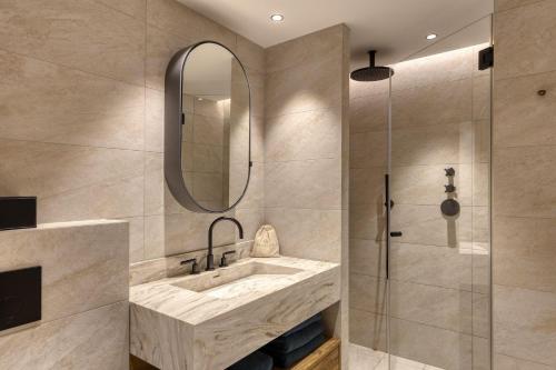 a bathroom with a sink and a shower at Winter Deluxe Chalet Megève in Megève