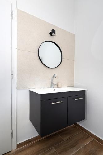 a bathroom with a sink and a mirror at Muse Studios & Apartments Escape in Agia Marina Aegina