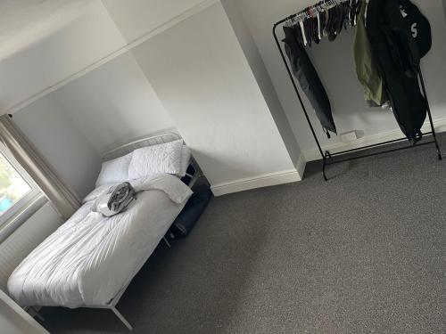 a small bed in a room with a mirror at House - Sleeps 4-6 - Parking - Pet friendly in Ilkeston