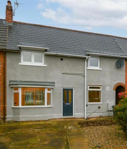 a gray house with a blue door and windows at House - Sleeps 4-6 - Parking - Pet friendly in Ilkeston