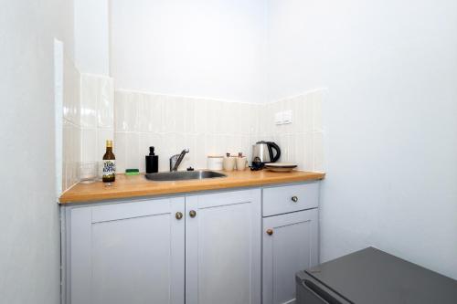 a kitchen with a sink and a counter top at Muse Studios & Apartments Escape in Agia Marina Aegina