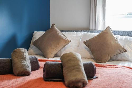 a white couch with some pillows on a bed at Cosy Home in Grimsby Town Centre in Grimsby