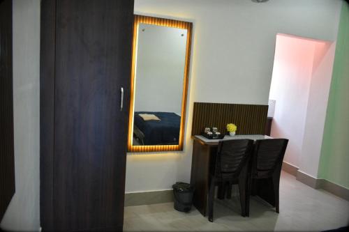 a room with a table and a mirror at Regal homes in Tezpur