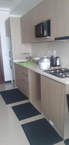 a kitchen with a sink and a stove top oven at Trizen luxury apartments Colombo Sri lanka in Colombo