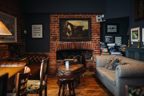 a living room with a couch and a fireplace at The Rose & Crown, Ashbury in Ashbury