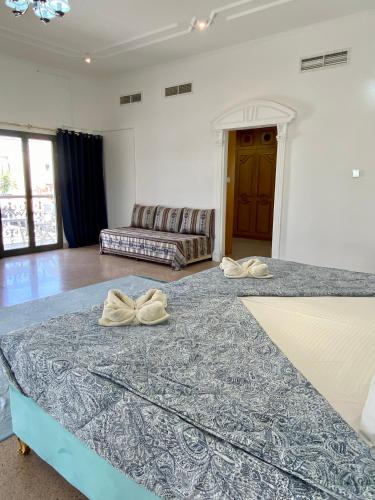a living room with a large bed and a couch at Arabian Nights Nook in Muscat