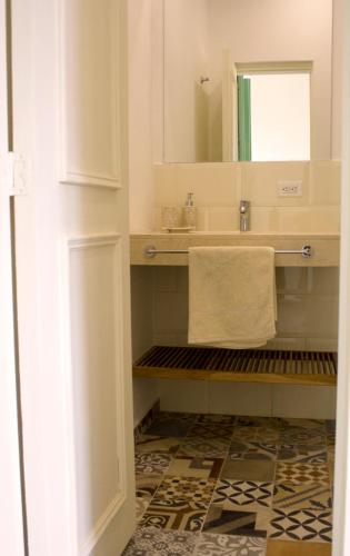 a bathroom with a sink and a mirror at Hotel Casa de la Vega in Bogotá
