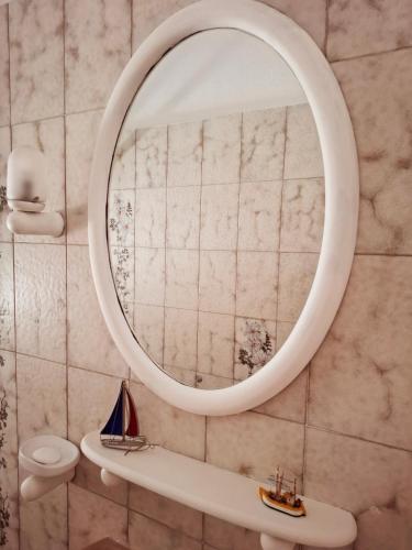 a bathroom with a mirror and a sink at Chez Dodo Ospedaletti in Ospedaletti