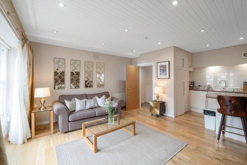 a living room with a couch and a table at Rose Street flat in Edinburgh