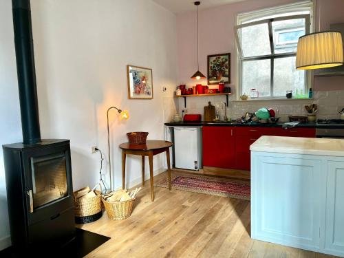 a kitchen with a fireplace and a stove at Casa di Kola in Zutphen