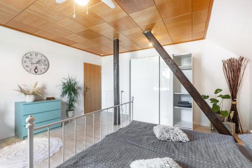 a bedroom with a bed and a clock on the wall at Ferienwohnung Beti in Korbach