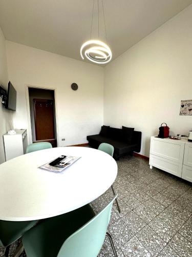 a room with a table and chairs and a couch at Hbhall Residenze Darsena in Milan