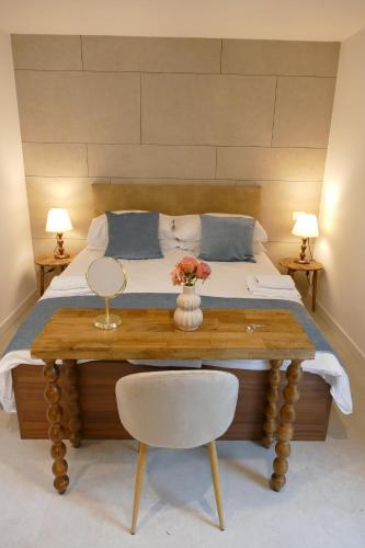 a bedroom with a bed and a table with flowers on it at Villa Falesia in Sistiana